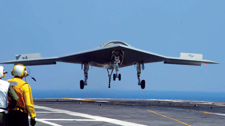 An x-47B demonstrator test aboard USS Theodore Roosevelt. The X-47B hooked the third wire on all its attempted autonomous carrier landings.