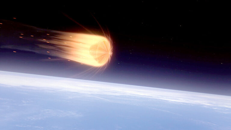 Image of a meteor entering earth's atmosphere, visible as a bright, fiery object against the curved horizon of earth, with space as background.
