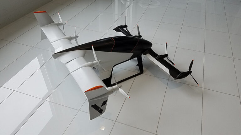 A black and white drone with multiple rotors displayed on a glossy tiled floor.