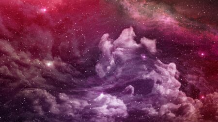 A colorful nebula in outer space with swirling clouds of pink, purple, and white gas, and scattered stars throughout.