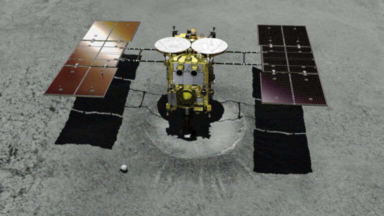 A spacecraft with extended solar panels and various instruments is parked on a rocky, gray surface, likely an asteroid or moon.