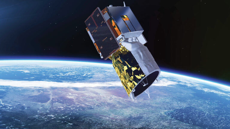 A satellite with solar panels and a metallic body orbiting above Earth, with the planet’s surface and atmosphere visible in the background.