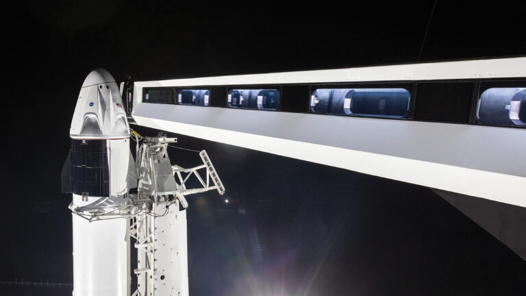 Countdown to Commercial Crew SpaceX Crew Dragon spacecraft on the launch pad, attached to the access arm and ready for a night launch.