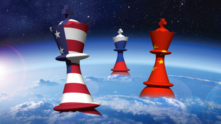 Three chess kings, each adorned with the flags of the United States, Russia, and China respectively, stand against a backdrop of outer space and Earth.