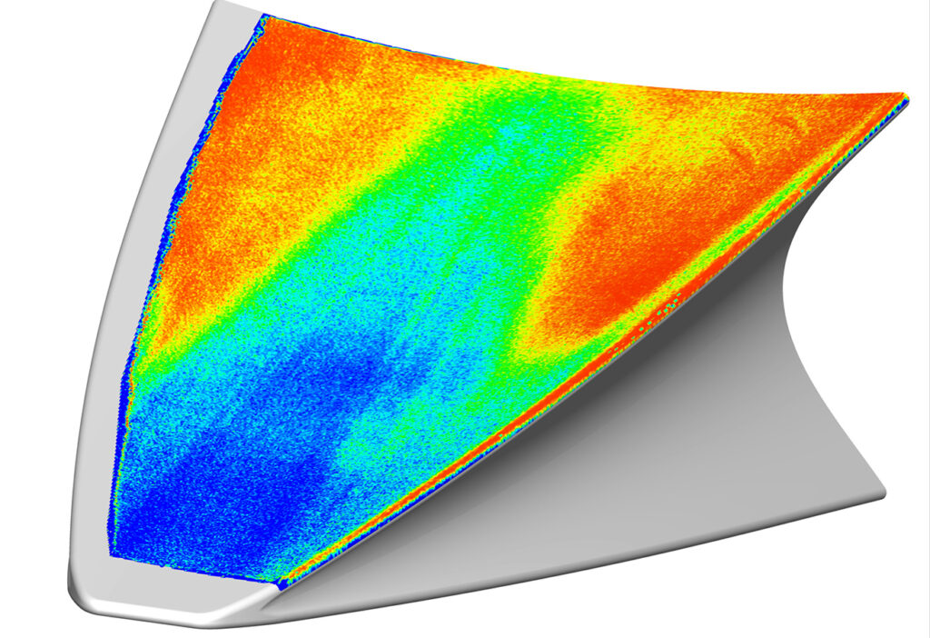 A computer-generated image shows a heat distribution map with colors ranging from blue (cooler) to red (hotter) on a curved surface, likely a component of a mechanical or aerospace structure.