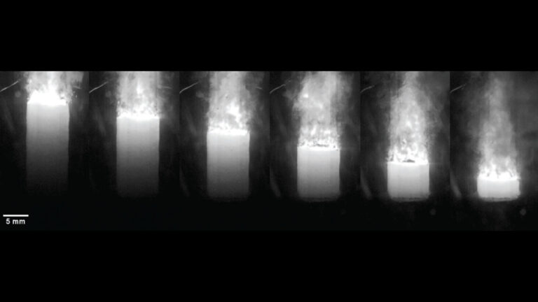 A sequence of images showing a cylindrical object emitting flames and smoke from the top, with a scale of 5 mm on the bottom left.