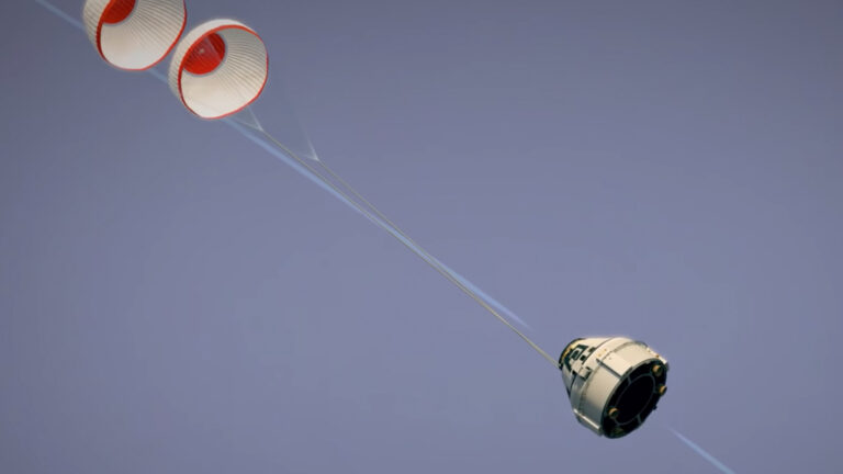A spacecraft capsule descending with two deployed parachutes against a clear sky.
