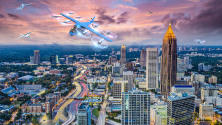 A futuristic cityscape featuring multiple flying vehicles above skyscrapers and a busy highway at sunset.