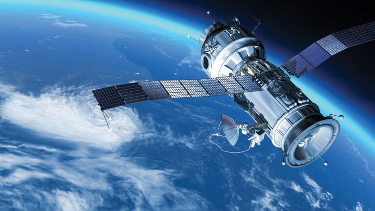 A satellite with extended solar panels orbits above the Earth against a backdrop of blue atmosphere and space.