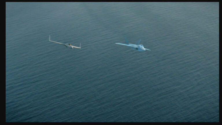 Two aircraft, one conventional and one appearing translucent, seen flying side by side over a large body of water.