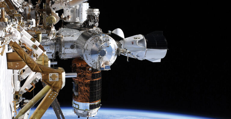 The image shows a spacecraft docked to the International Space Station, with Earth visible in the background. The scene illustrates the docking mechanism and external modules of the ISS.