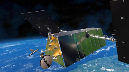 A satellite with extended solar panels orbits above the Earth against a backdrop of outer space.