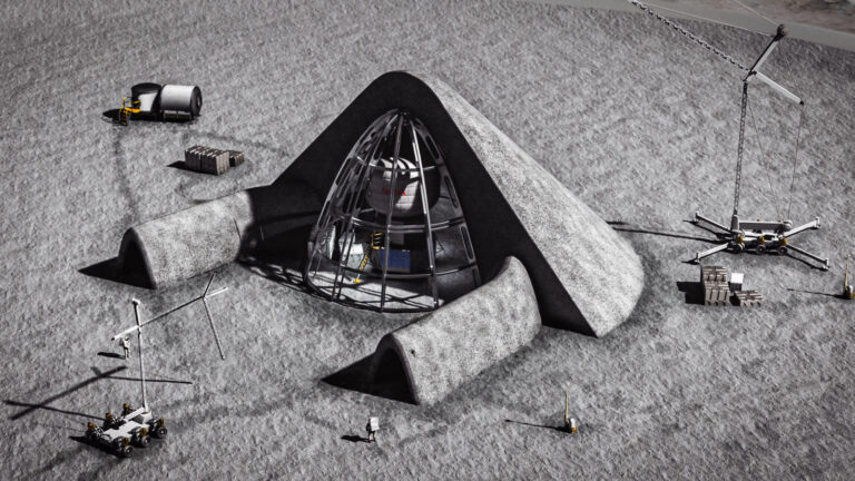 A futuristic, dome-shaped structure with nearby machinery sits on a barren, grey landscape. Boxes, equipment, and a person in a white suit are visible around the building, indicating a space exploration setting.