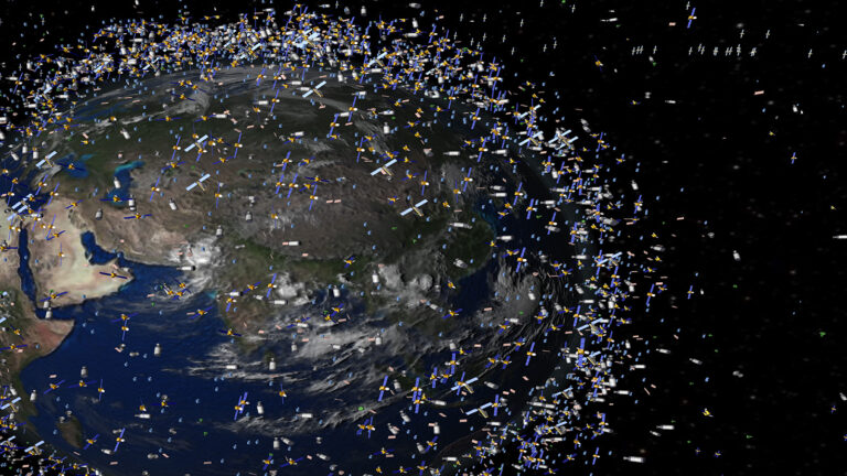 Illustration of Earth's orbit showing a dense collection of satellites and space debris. The Earth is partially visible with an abundance of scattered objects surrounding it in space.