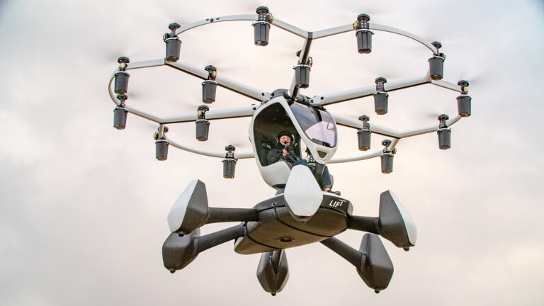 A person is piloting a futuristic drone-like flying vehicle with multiple rotors, flying in a cloudy sky.