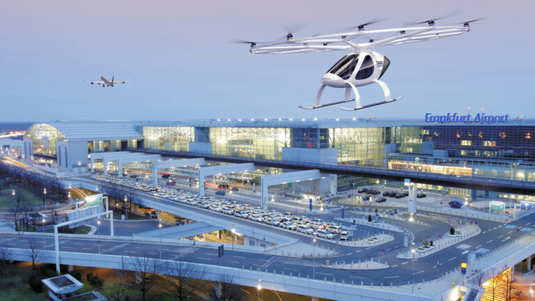 A futuristic passenger drone hovers above a busy terminal at Frankfurt Airport, with numerous cars and an airplane in the background during twilight.