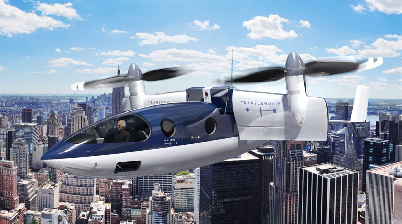A futuristic aircraft with propellers flies above a city with tall buildings under a blue sky.