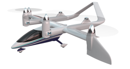 A white and blue electric VTOL aircraft with four sets of rotors, two on each wing, is shown against a plain background.