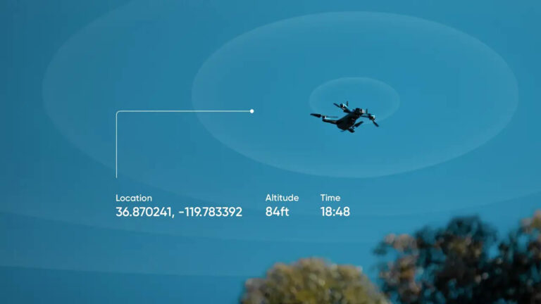 A drone is flying in the sky at 84 feet altitude, with GPS coordinates 36.870241, -119.783392, at 18:48. Trees are visible at the bottom of the image.