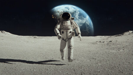 Astronaut in a spacesuit walking on the moon's surface with Earth visible in the background against a dark sky.