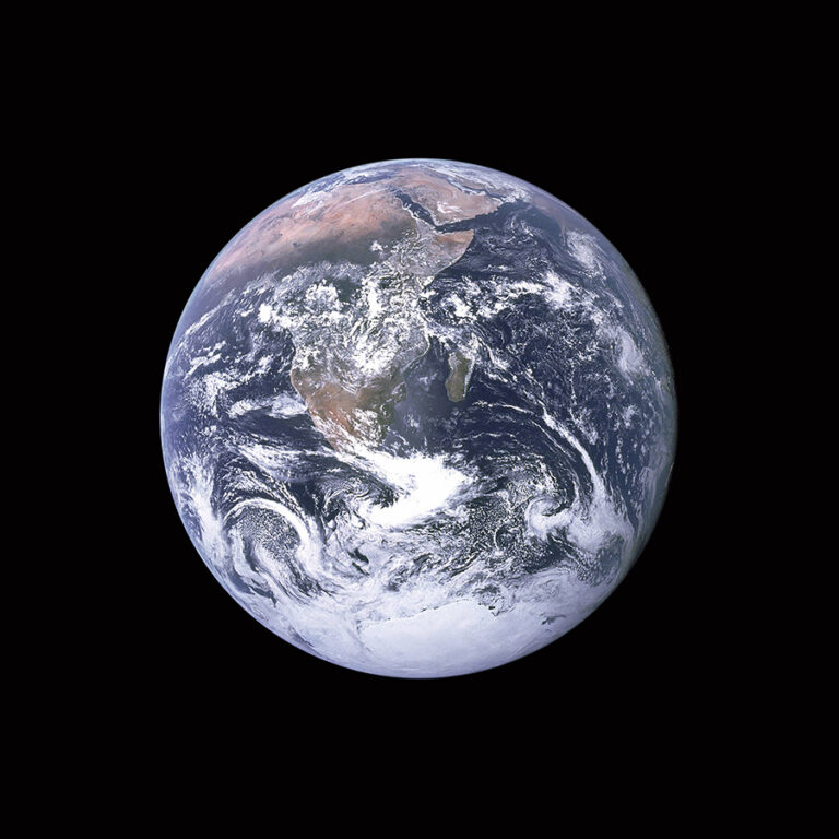 Image of Earth viewed from space, showing continents including Africa and South America, surrounded by blue oceans and white cloud formations against a black background.