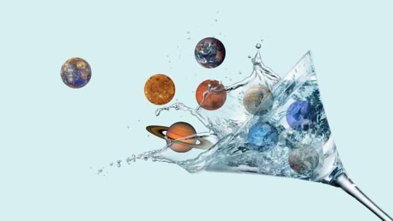 Planets splashing out of a tilted martini glass filled with water.