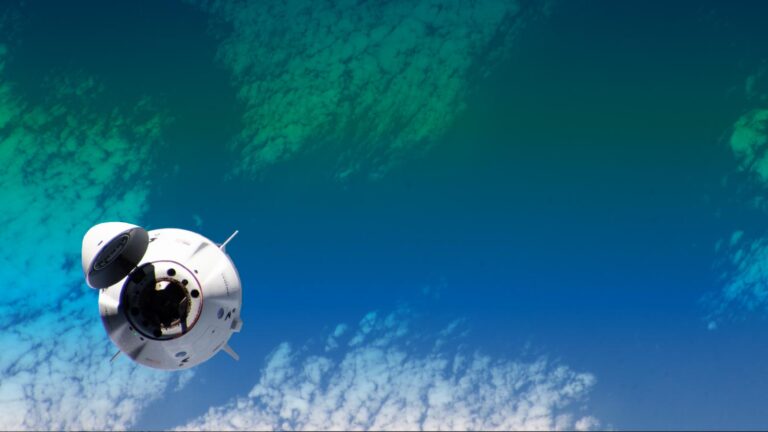 A spacecraft orbits above Earth with parts of the planet's atmosphere and clouds visible below. The spacecraft's open hatch is prominent in the image.