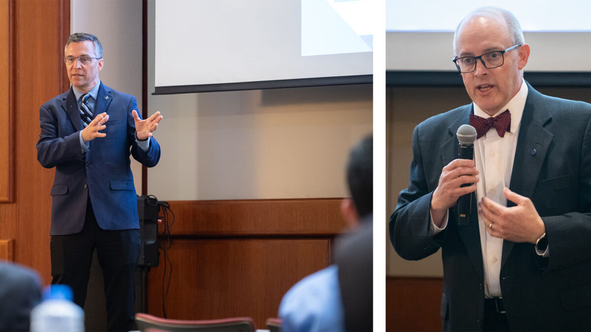 Two men deliver presentations in a lecture setting. The man on the left gestures with his hands, while the man on the right speaks into a microphone. Both are dressed in formal attire.