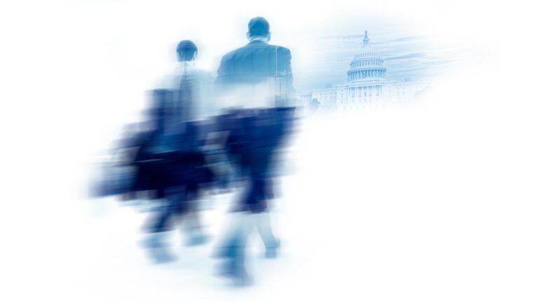 Two blurred figures walk toward a distant Capitol Building on a white background.