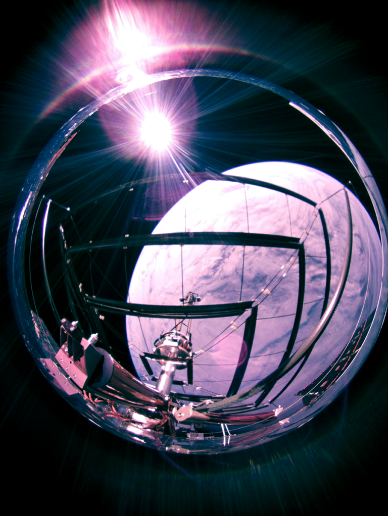 On-orbit demonstrations and ground tests push technology forward A spherical structure with beams and a central device is set against a backdrop of a planet and a bright light source, suggestive of space exploration equipment.