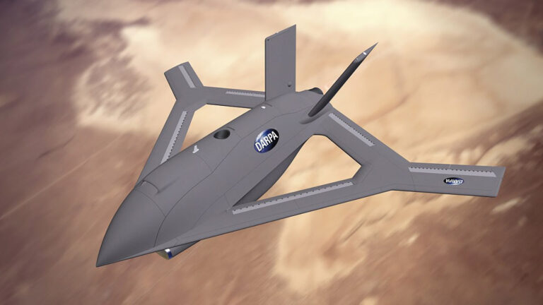 A futuristic unmanned aerial vehicle with a sleek, angular design flies over a desert landscape. It features logos of NASA and DARPA on its body.