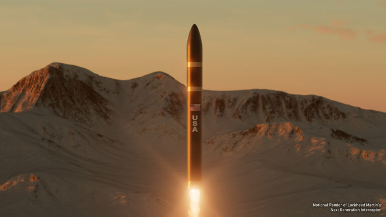 A missile launches vertically against a backdrop of snow-covered mountains at sunset.