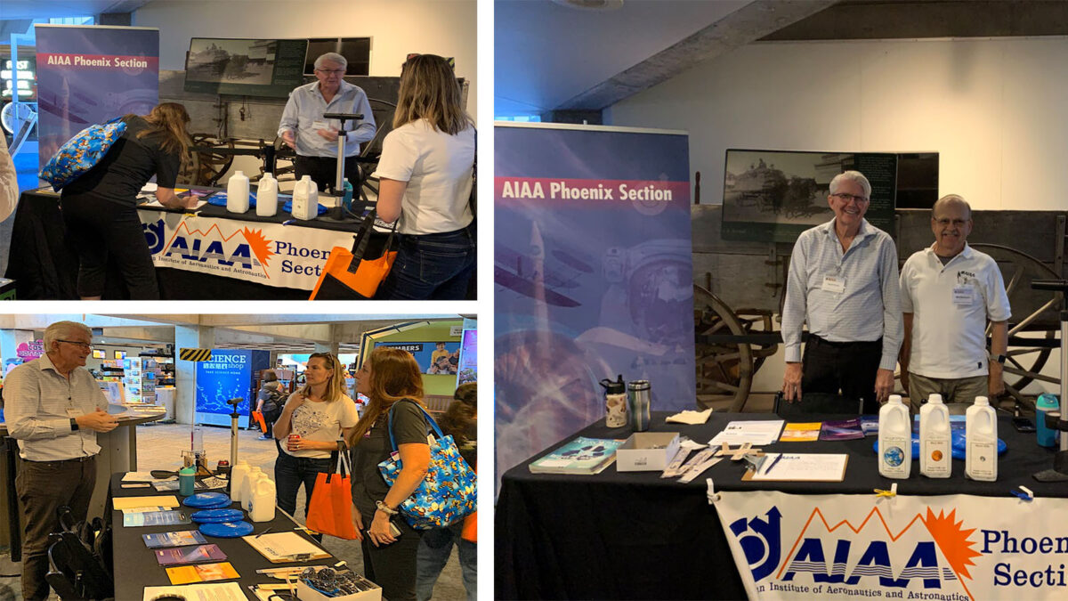 AIAA Phoenix Section booth with two people behind the table displaying promotional materials and merchandise.