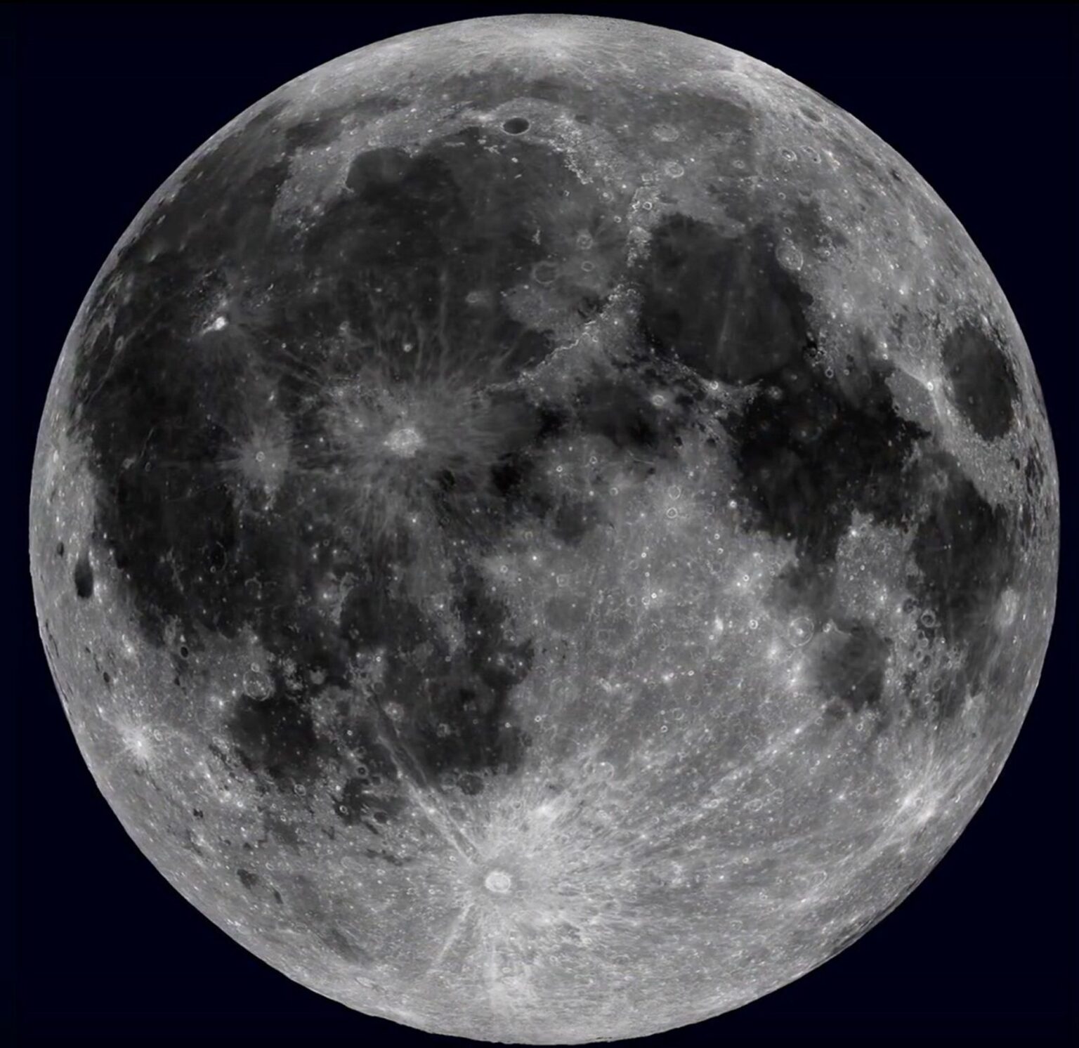Full moon with detailed surface features against a dark sky, showing craters and gray shades.